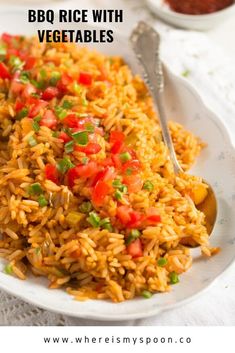 a white plate topped with rice and veggies