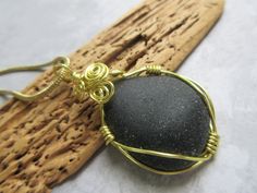 "Olive Green Wire Wrapped Sea Glass Pendant Sea Glass Jewelry by seaglassin. This piece of olive green sea glass is wrapped in gold plated wire. It is very nicely smoothed and has a beautiful shape. It is so dark that it almost looks black but when held to the light, it is olive green. It is  1 1/8\" wide by 2\" in length from the top of the wire to the bottom of the sea glass. (28.5mm x 50.8mm). It will come with an 18\" (45.7cm) gold plated chain. Some photos show it beside a dime for size reference. If you would like to see more of my sea glass pendants, click on: http://www.etsy.com/shop/seaglassin?section_id=6176338 54             SEAGLASSIN SHIPS WORLDWIDE" Green Beach, Ocean Jewelry, Sea Glass Pendant, Prince Edward Island, Looks Black, Prince Edward, Green Sea, Sea Glass Jewelry, Beach Glass