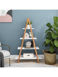 a living room with blue walls and a white ladder shelf next to a potted plant