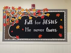 a black and white sign that says fall for jesus he never leaves on the tree