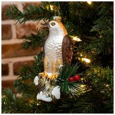 an owl ornament hanging from a christmas tree