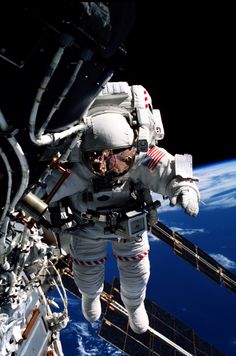 an astronaut floating in the air above earth