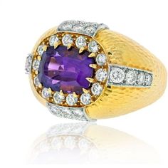 Discover a truly enchanting piece that will capture your heart and elevate your style. Introducing the David Webb 18K Yellow Gold Oval Amethyst and Diamond Hammered Finish Ring. Crafted with meticulous attention to detail, this ring exudes elegance and sophistication. The centerpiece of this exquisite ring is a mesmerizing cushion-shaped amethyst, measuring approximately 11.8mm x 9.5mm. Its vibrant purple hue is the epitome of luxury and will undoubtedly make a statement.Adding to the allure are Luxury Oval Amethyst Ring With Center Stone, Luxury Oval Amethyst Ring With Polished Finish, Luxury Polished Oval Amethyst Ring, Oval Brilliant Cut Amethyst Ring In Yellow Gold, David Webb, Yellow Rings, Yellow Jewelry, Amethyst And Diamond Ring, Emerald Cut Diamonds