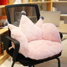 an office chair with a pillow on top of it