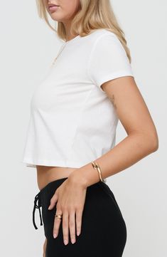 A cropped, boxy silhouette adds elevated style to this classic white T-shirt boasting a sustainable design. Crewneck Short sleeves 60% recycled cotton, 40% recycled polyester Hand wash, line dry Imported Elevated Style, Crop T Shirt, Crop Tshirt, Anniversary Sale, Sustainable Design, Princess Polly, White T Shirt, Classic White, Recycled Cotton