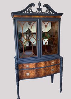 an old fashioned china cabinet with glass doors