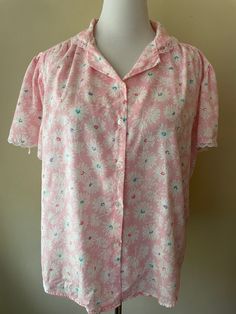 "Vintage 80s pink button up shirt, lace embroidered collar and sleeves. Made by Diamond Hill, marked size 42. Polyester cotton blend. Pink with white floral pattern, teal, purple and dark pink accents.  Please ask questions!  Measurements (laid flat):  Tag Size: 42 Length: 23\" Pit to Pit: 24\"x2 Waist: 25\"x2 Condition: Good vintage condition, no issues noted.  The vintage pieces I sell have all led a previous life and may tell their stories through minor imperfections. I'll do my best to indicate overall condition, but please refer to the pictures. Your purchase continues the life of this garment...what stories will you tell while wearing it?  Please note there may be a slight difference in color when comparing the actual garment to the monitor image. (0466)" Lace Trim Button-up Tops For Daywear, Feminine Pink Floral Print Shirt, Pink Floral Print Button-up Shirt, Spring Lace Trim Button-up Shirt, Button-up Tops With Lace Collar For Daywear, Fitted Pink Shirt For Daywear, Pink Floral Print Collared Blouse, Pink Button-up Shirt For Daywear, Pink Collared Top With Button Closure