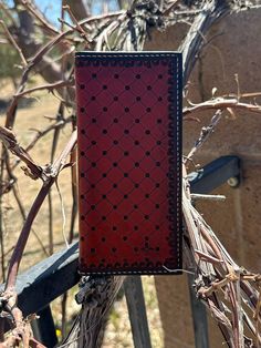 a red and black book sitting on top of a tree