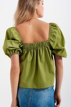 This oversized 100% Cotton poplin top boasts of on-trend balloon sleeves, elasticated trimmings, and a cropped length. The square neck and back complement the puffy short sleeves and smock aesthetic. The green hue is trending strong this season, making this the perfect complement to a pair of high-waisted jeans, trousers, or shorts. In our photos, we pair it with our Distressed Hem Denim Mini Skirt, worn untucked for that relaxed aesthetic. The model is 5’9” with measurements of 32-24-35 and is Cotton Poplin Top, High Neck Jumper, Fluffy Sweater, Balloon Sleeve Top, Poplin Top, Ribbed Midi Dress, Satin Mini Dress, Green Tops, Denim Mini