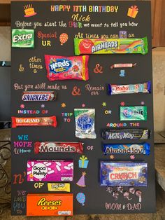 a chalk board with candy on it that says happy birthday and is written in different languages