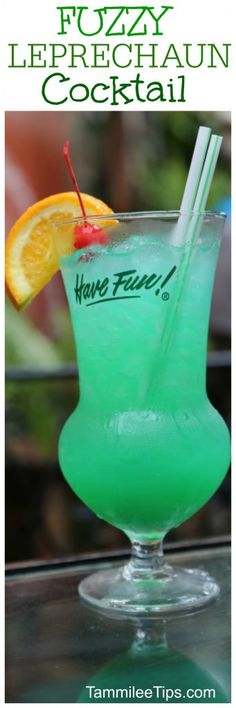 a green cocktail in a glass with orange wedges on the rim and text overlay that reads fuzzy leprechaun cocktail