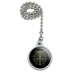 a black and silver necklace with a tree design on the front, hanging from a ball chain