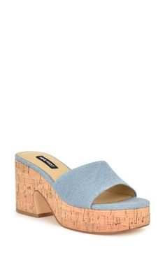 A cork-textured platform and block heel lend retro appeal to a chunky slide sandal crafted with a light-wash denim upper. 3" heel; 1 1/4" platform Textile upper/synthetic lining and sole Imported High Heel Cork Sandals For Spring, Spring High Heel Cork Sandals, Spring Cork Heels With Round Toe, Casual Cork Wedge Sandals For Summer, Summer Platform Heels With Cork Material, Spring Platform Cork Heels, Spring Platform Heels With Cork Material, Summer Cork Platform Heels, Spring Cork Platform Heels