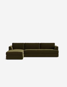 a large sectional couch sitting on top of a white floor next to a footstool