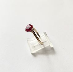 This is a gorgeous vintage 1970s 14 karat yellow gold high set hot pink tourmaline ring. The tourmaline stone is 1.25 carats. The band is 14 K. The stone rises 1/4 inch from the base of the ring. The ring is a size 8. It must have been resized at one point because only part of the gold mark is visible. It has been acid tested and guaranteed 14 K. The stone color is a beautiful deep hot pink. This would make a beautiful engagement ring for that someone special or a perfect ring to wear for that s Gold Heart Cut Ruby Birthstone Ring, Classic Ruby Ring With Heart Cut And Prong Setting, Classic Ruby Ring With Heart Cut, Classic Heart Cut Ruby Ring, Classic Ruby Heart Cut Birthstone Ring, 14k Stamped Ruby Ring Round Cut, 14k Stamped Round Cut Ruby Ring, Classic 14k Gold Ruby Ring With Heart Cut, Classic 14k Gold Heart Cut Ruby Ring