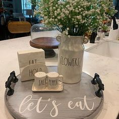 there is a cake that says eat flowers, let's eat coffee and two mugs