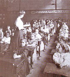 an old black and white photo of a classroom full of children