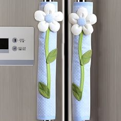 the refrigerator door handle is decorated with flowers and leaves, which are attached to it's side