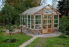 a small greenhouse in the middle of a yard