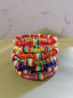 multicolored bracelets stacked on top of each other