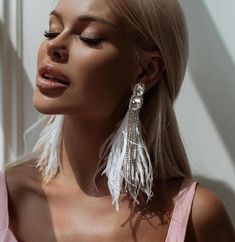 Elevate your style with our Elegant Long Feather Earrings with Rhinestones. These stunning statement pieces are not just jewelries, they are a celebration of femininity, sophistication, and elegance. Handcrafted with meticulous attention to detail, these earrings feature shimmering rhinestones that catch the light beautifully, creating a captivating sparkle that will surely turn heads. The graceful feathers add a touch of bohemian chic to the overall design, making these earrings the perfect ble White Earrings, Delicate Earrings, Feather Earrings, Bohemian Chic, Elegant Earrings, Jewelry For Women, Luxury Outfits, Statement Jewelry, Face Shapes