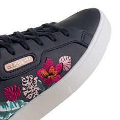 ADIDAS SLEEK SHOES COMFORTABLE SHOES DESIGNED IN COLLABORATION WITH HER STUDIO LONDON. There's beauty in strength and power in softness. Show off both in these adidas Sleek shoes with florals blooming across the sleek, retro upper. Slip them on and flaunt the casual confidence you do best. Narrow fit Lace closure Leather upper Allover print Rubber outsole Imported Product color: Legend Ink / Vapour Pink / Crystal White Style #FY3663