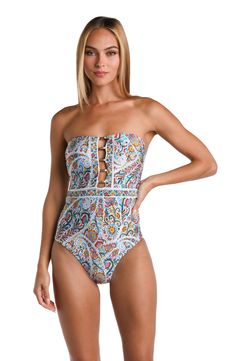 The print on this one piece swimsuit is a detailed and intricate paisley pattern, featuring a multitude of colors like blues, reds, and oranges with touches of white, creating a rich and ornate design. This versatile suit easily transitions to a strapless bandeau, offering two looks in one gorgeous design. A subtle sweetheart neckline accentuates the bust by creating curves while lattice front detail covered in gold tubes offer subtle hints of skin. Moderate coverage in back keeps the look class Printed Strapless Swimwear, Paisley Print Beachwear Swimwear, Festival Beachwear With Paisley Print, Paisley Print Beachwear For Festivals, Paisley Print Swimwear For Poolside, Paisley Print Swimwear For Festival And Beach Season, Paisley Print Swimwear For Festival Beach Season, Paisley Print Swimwear For Beach Festival, Paisley Print Beachwear Swimwear For Pool