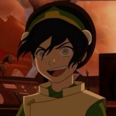 an anime character with black hair and green eyes in front of a computer screen, smiling at the camera