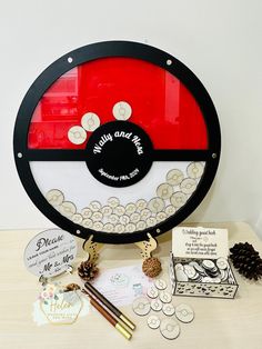 a table topped with lots of different items on top of a wooden table next to a pine cone