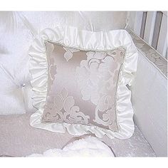 a white pillow sitting on top of a couch