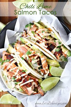 chicken and avocado tacos in a cast iron skillet with lime wedges