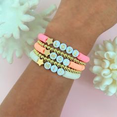 the bracelets are decorated with different colored beads and gold stars on each one side