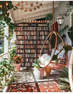 a room filled with lots of books and plants