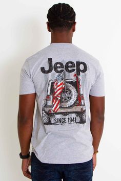 a man wearing a jeep t - shirt with an american flag on it