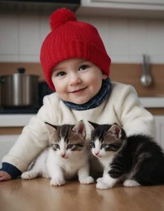 two small kittens sitting next to each other on a wooden table in a kitchen