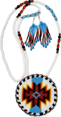 This exquisite handmade beaded jewelry set, crafted in a native-inspired style, showcases the artistry of Aztec beadwork using Premium Czech beads in size 11/0. The vibrant color palette features a harmonious blend of White, Red, Black, Cyan Blue creating a striking visual appeal. The necklace, with a 17-inch drop, is adorned with intricate patterns that lead to a stunning medallion pendant, measuring 3.2 inches in diameter. The pendant's back is lined with soft suede leather, ensuring a comfortable fit against the skin. Complementing the necklace are matching hook earrings, 3 inches long and 0.5 inches wide, echoing the intricate beadwork and color scheme of the necklace. This set is a perfect fusion of traditional craftsmanship and modern elegance, ideal for making a bold statement. Southwestern Red Beaded Necklaces, Red Southwestern Beaded Necklace, White Southwestern Hand-strung Beaded Necklace, Red Hand-strung Spiritual Beaded Necklaces, Red Southwestern Hand-strung Beaded Necklaces, Cyan Blue, Medallion Necklace, Handmade Beaded Jewelry, Czech Beads