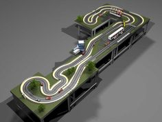 an overhead view of a race track with cars driving on the road and overpass