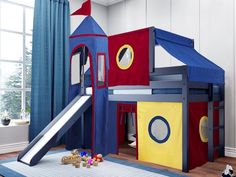 a child's play house with a slide and climbing tower in the middle of it