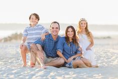 a family poses for a photo on the beach