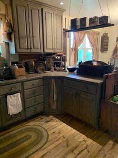 a large kitchen with wooden floors and cabinets