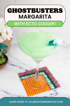 a close up of a margarita glass on a table with text overlay that reads, ghostbusters margarita witheto cooler