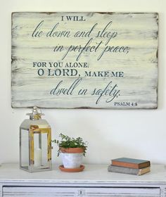 a wooden sign on top of a white dresser