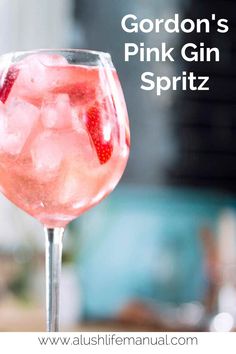 a pink gin spritz in a wine glass