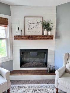 a living room with two chairs and a fireplace