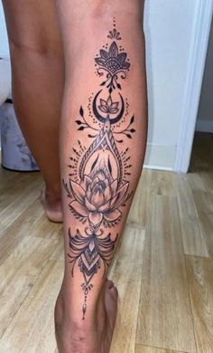 a woman's leg with tattoos on it, and a flower in the center