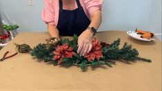 an older woman is arranging christmas decorations on a table