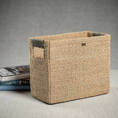 a basket sitting on top of a table next to two books