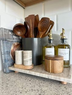 wooden utensils and other kitchen items sit on a shelf