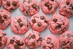 pink chocolate chip cookies on a baking sheet lined with parchment paper, ready to be eaten