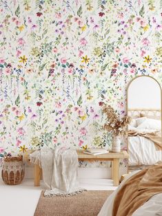 a bedroom with floral wallpaper and a bed in the foreground, next to a mirror